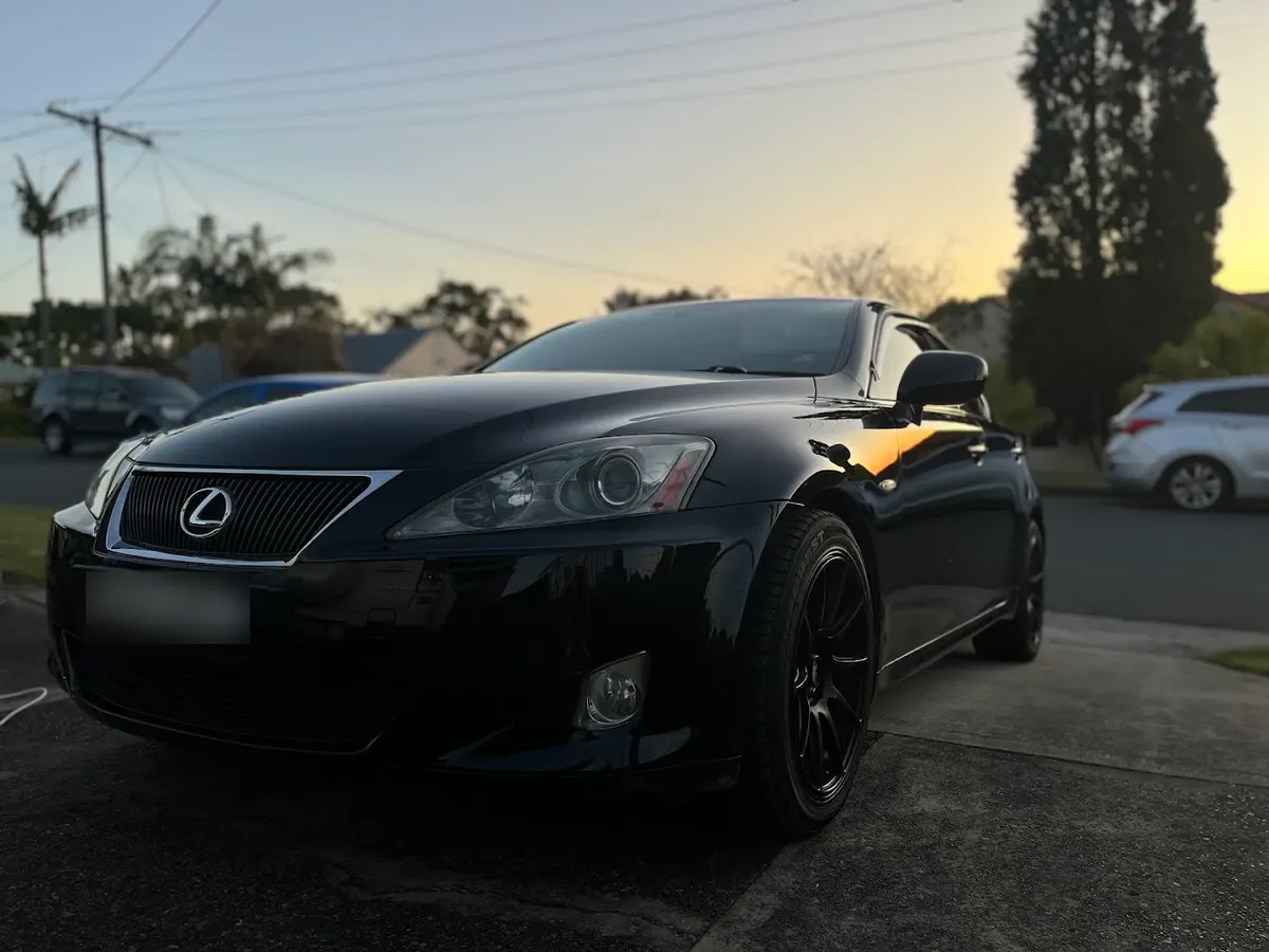 Black Lexus IS sedan at dusk after a hand detail