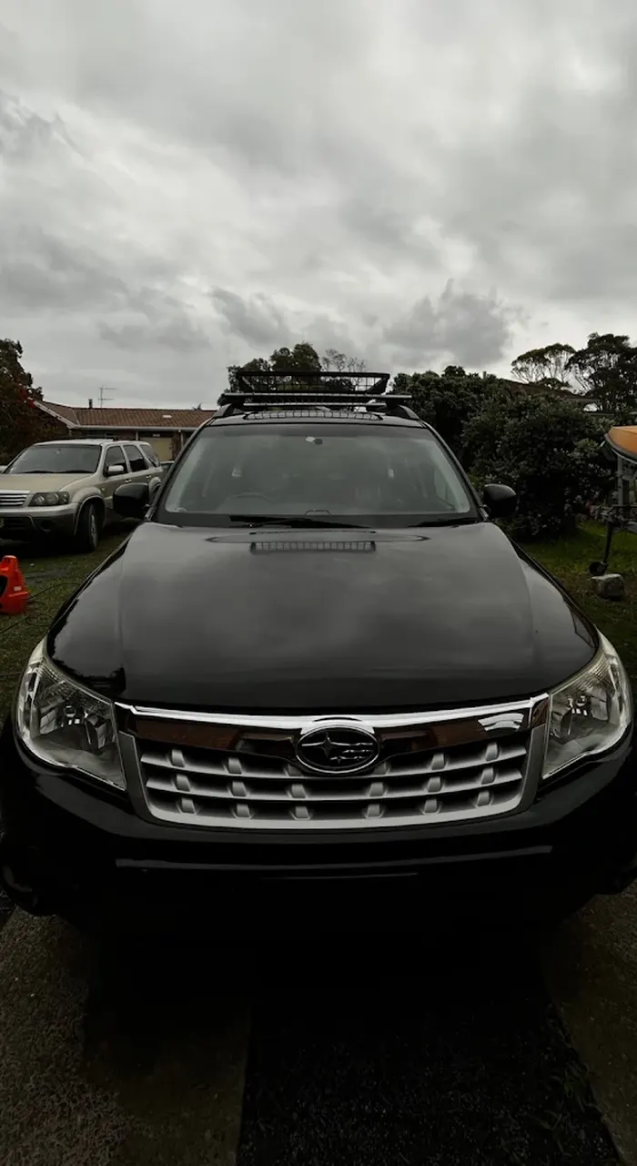 Black Subaru Forester with roof racks after a detail